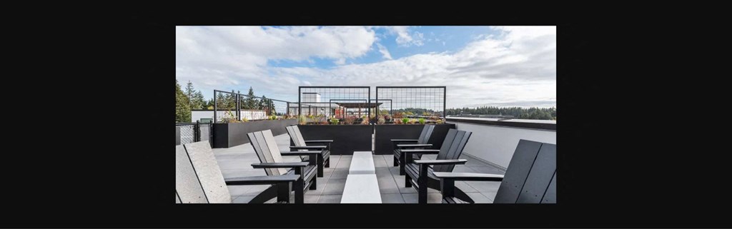 the patio on the top of the building has tables and chairs