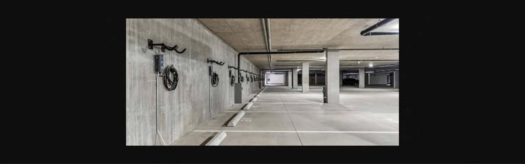 the inside of a building with a long hallway with white floors and walls