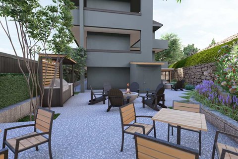 A patio with wooden chairs and tables is surrounded by a building and greenery.