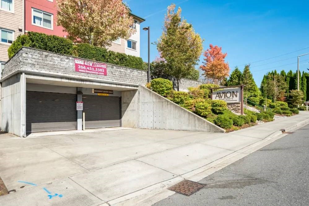 A building with a sign that says "AVION" is located on the side of a street.