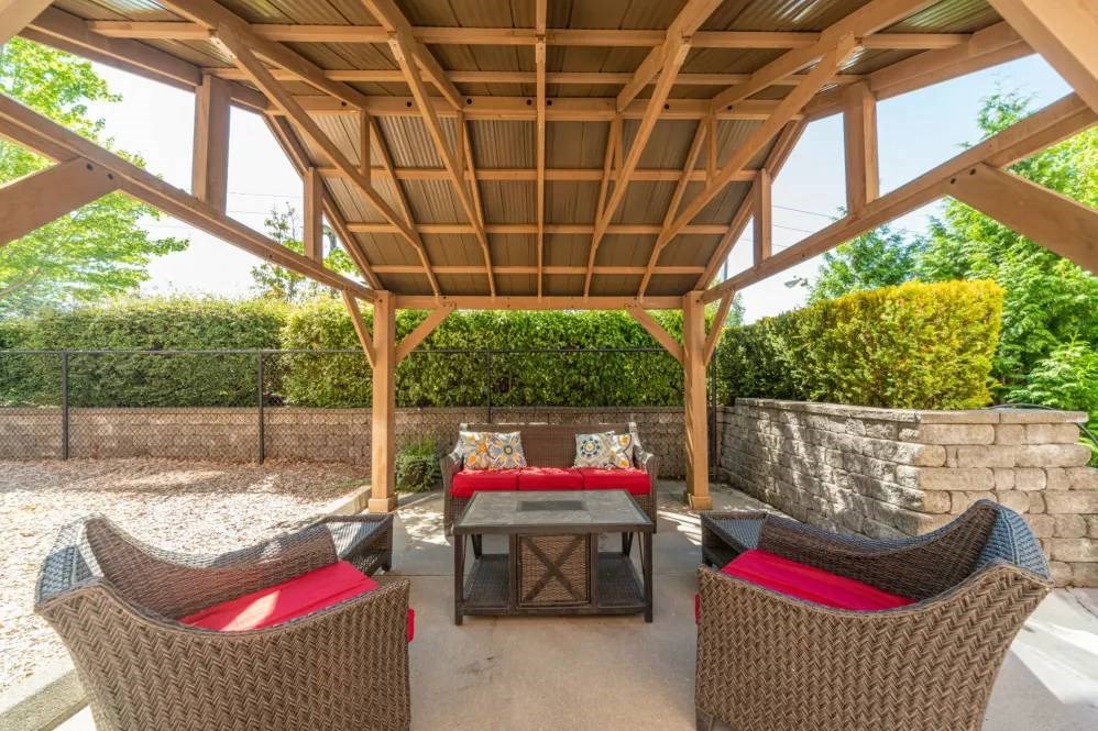 A wooden patio with a table and chairs.