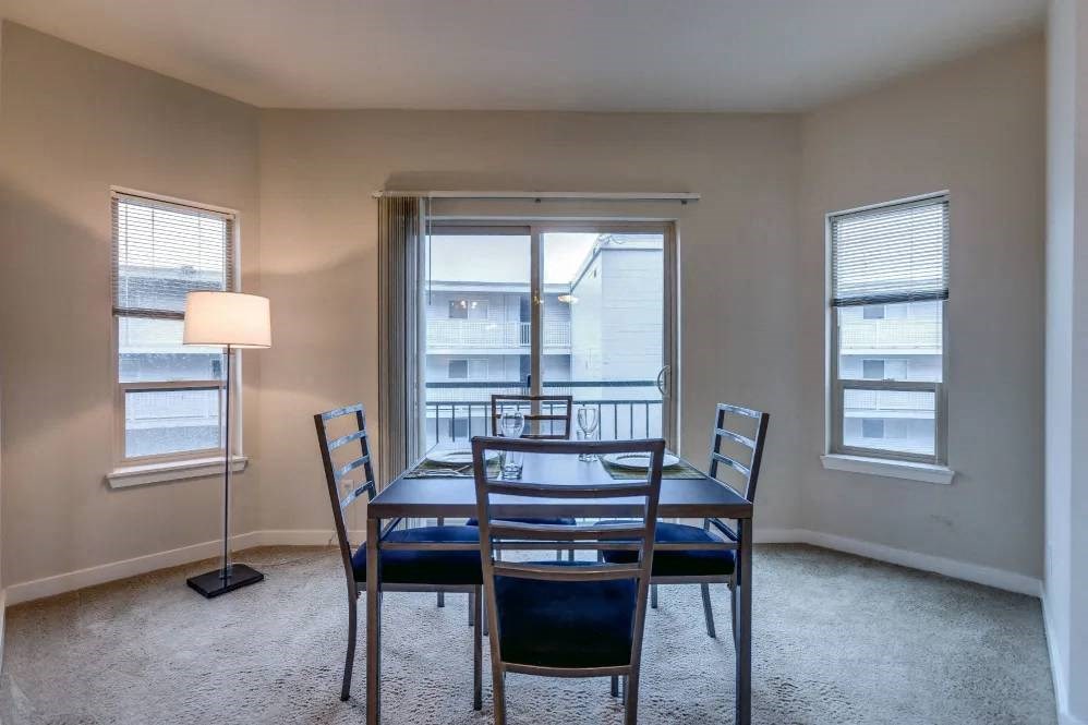 A dining room with a table and chairs.