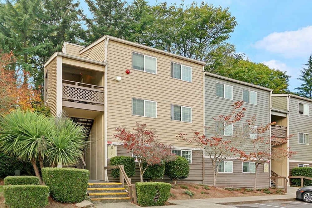 A two-story apartment building with a balcony on the second floor.