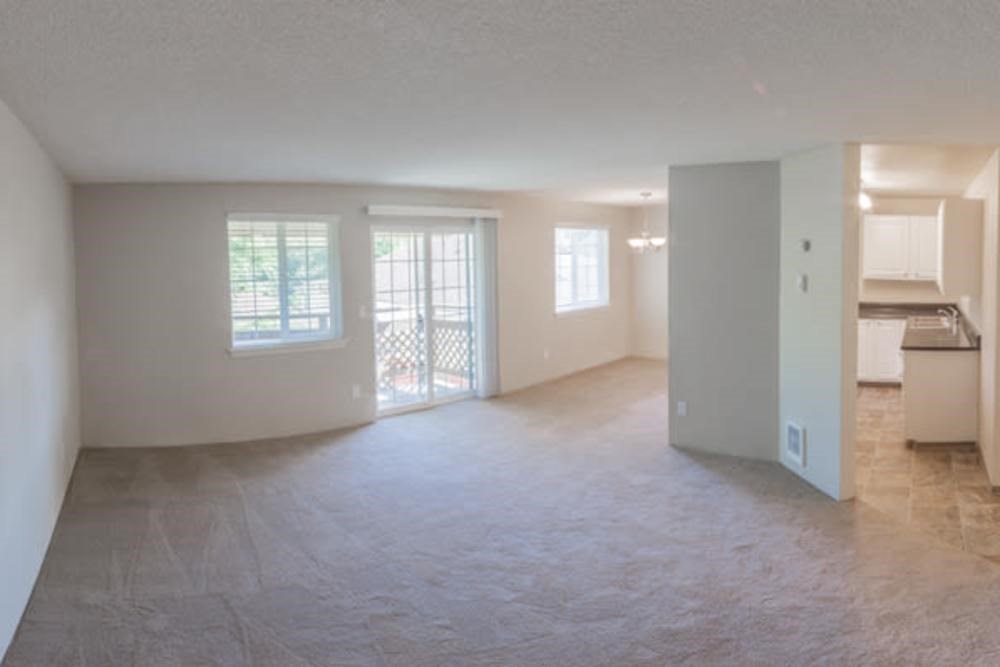 Empty room with a sliding glass door leading to a balcony.