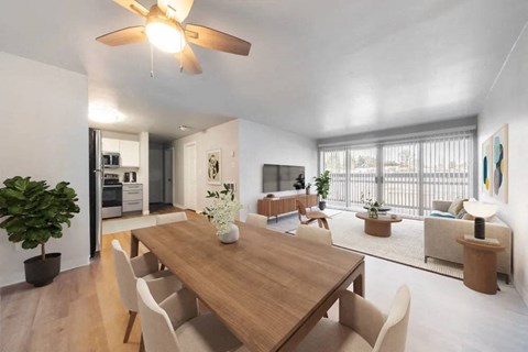 A modern dining room with a wooden table and chairs.