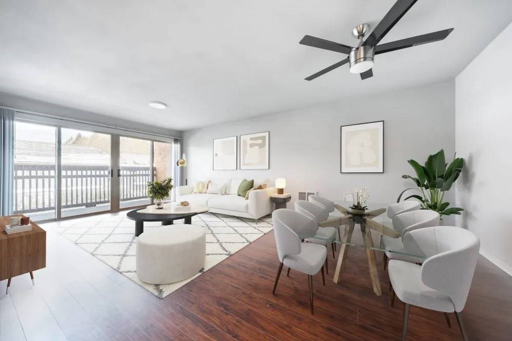 A modern living room with a dining table set up.
