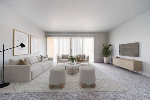 A modern living room with a large sofa, a coffee table, and a television.