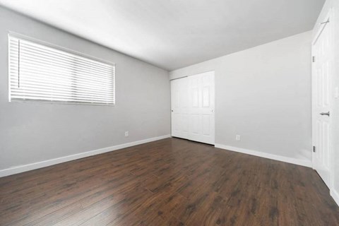 A room with wooden floors and white walls.