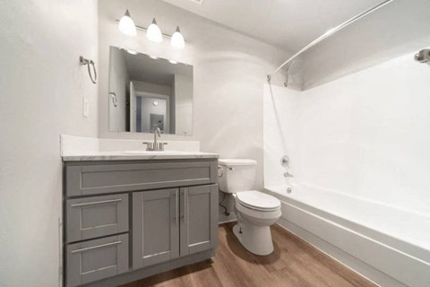 A bathroom with a white toilet and a white sink.