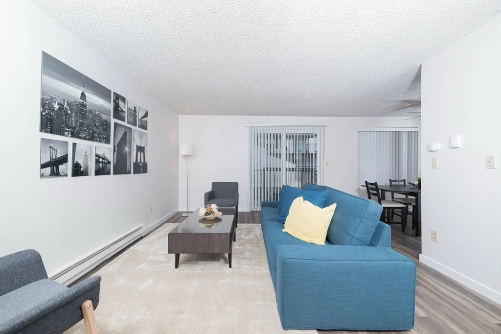 A living room with a blue couch and a coffee table.