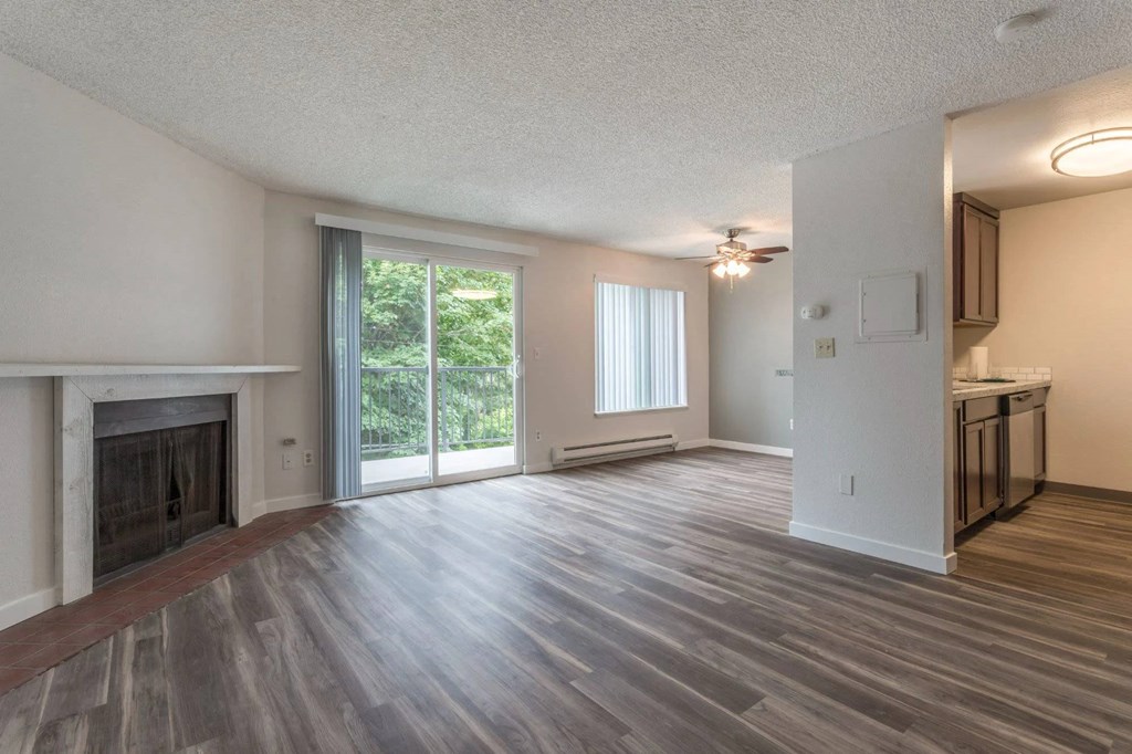 A spacious living room with a fireplace and sliding glass doors.