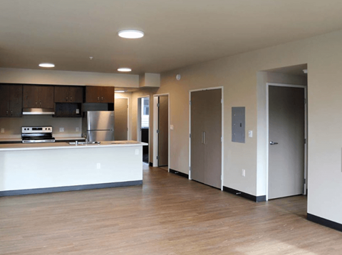 A kitchen with a white counter and a stainless steel oven.