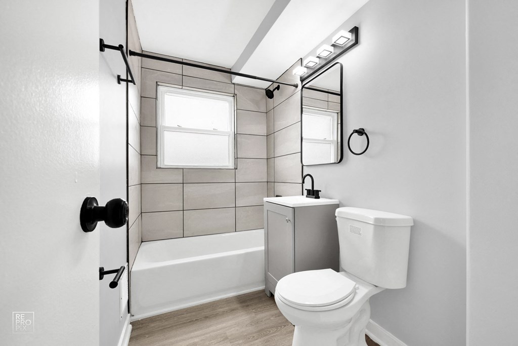 a bathroom with gray walls and white fixtures