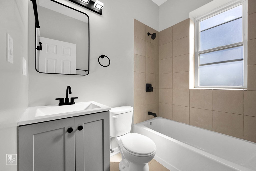 a bathroom with a sink toilet and bathtub