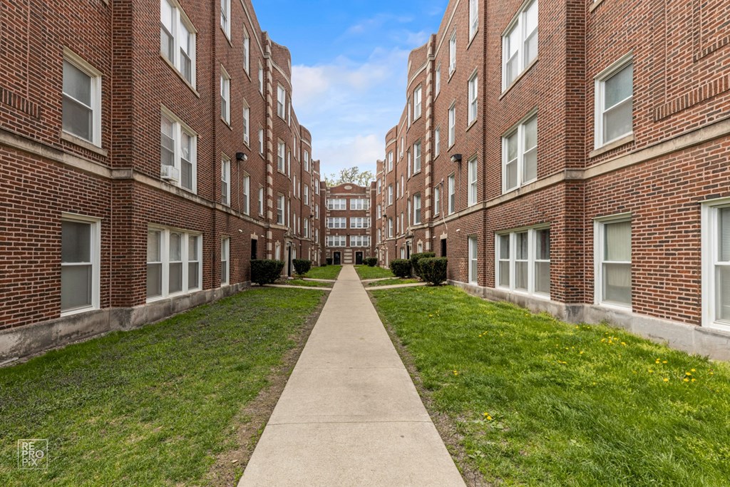 a walkway between two large brick buildings