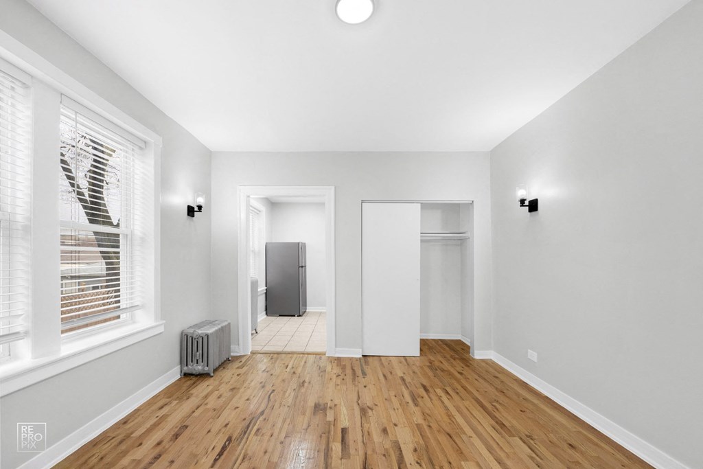 a living room with hardwood floors and grey walls