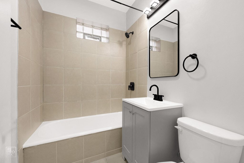 a bathroom with a bathtub and a sink