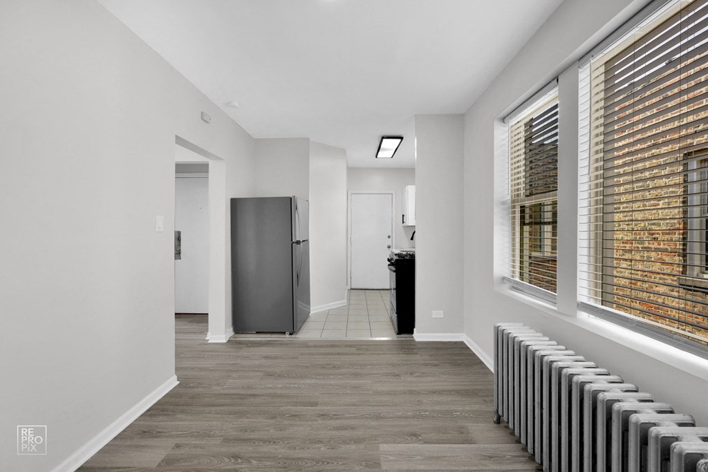 a bedroom with a medium sized bed and a radiator on the side of the bed