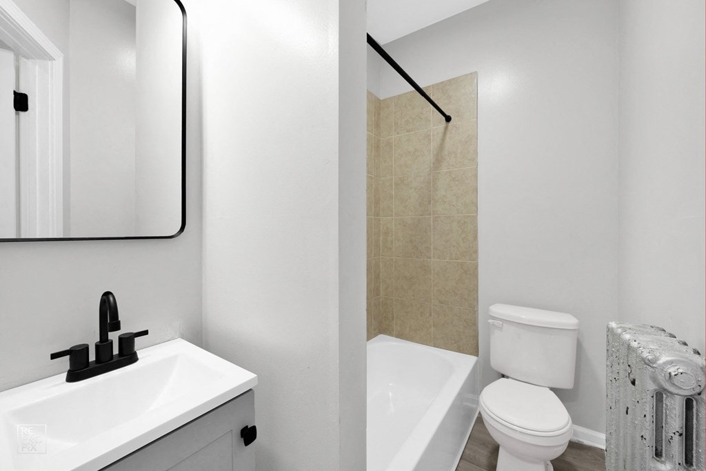 a bathroom with a sink toilet and bathtub