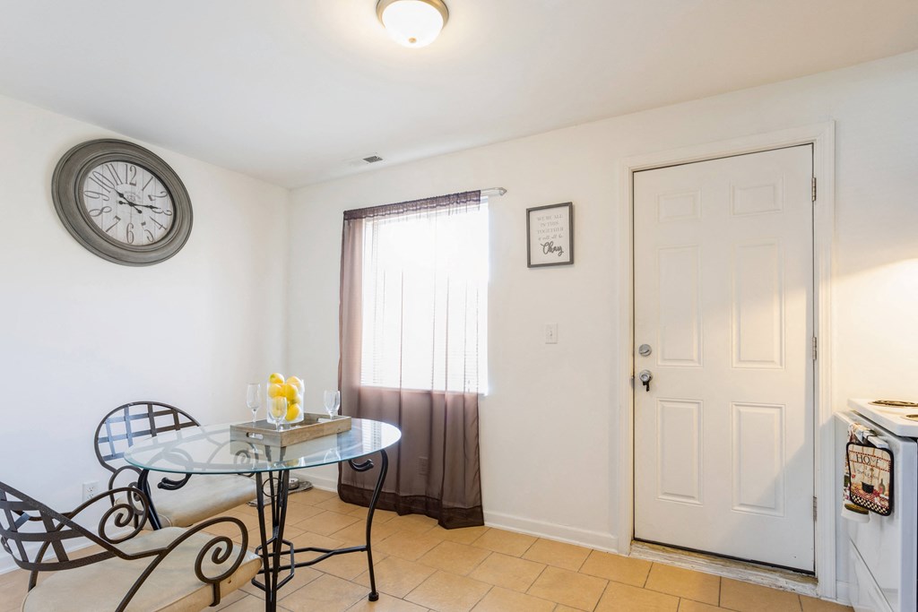 a dining room with a table and a clock on the wall