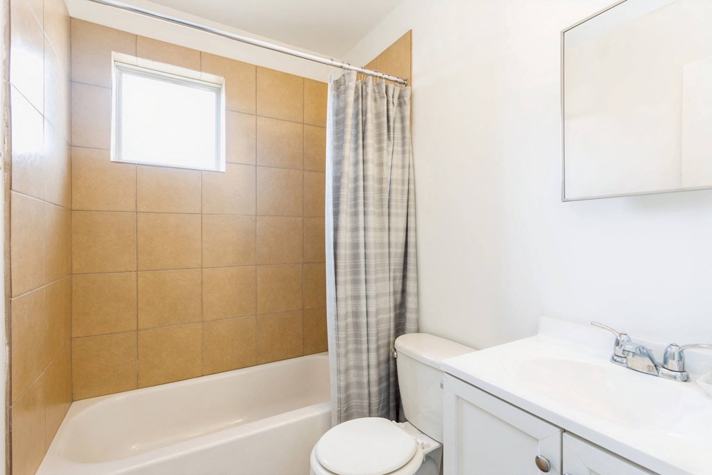 a bathroom with a sink toilet and a bath tub