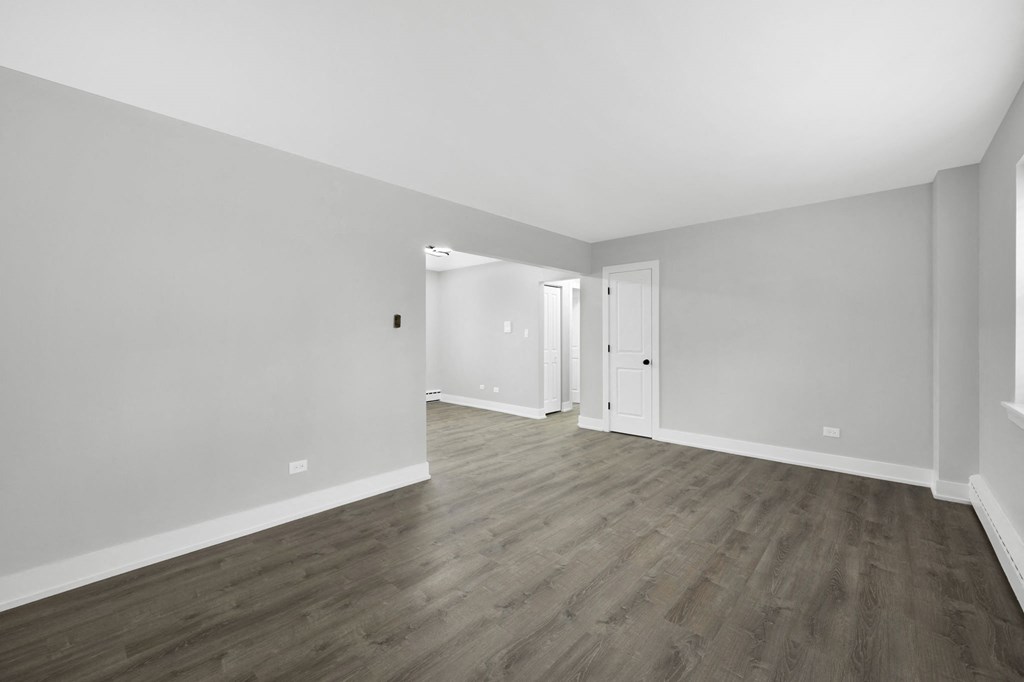 a bedroom in a 555 waverly unit with gray walls and hardwood floors