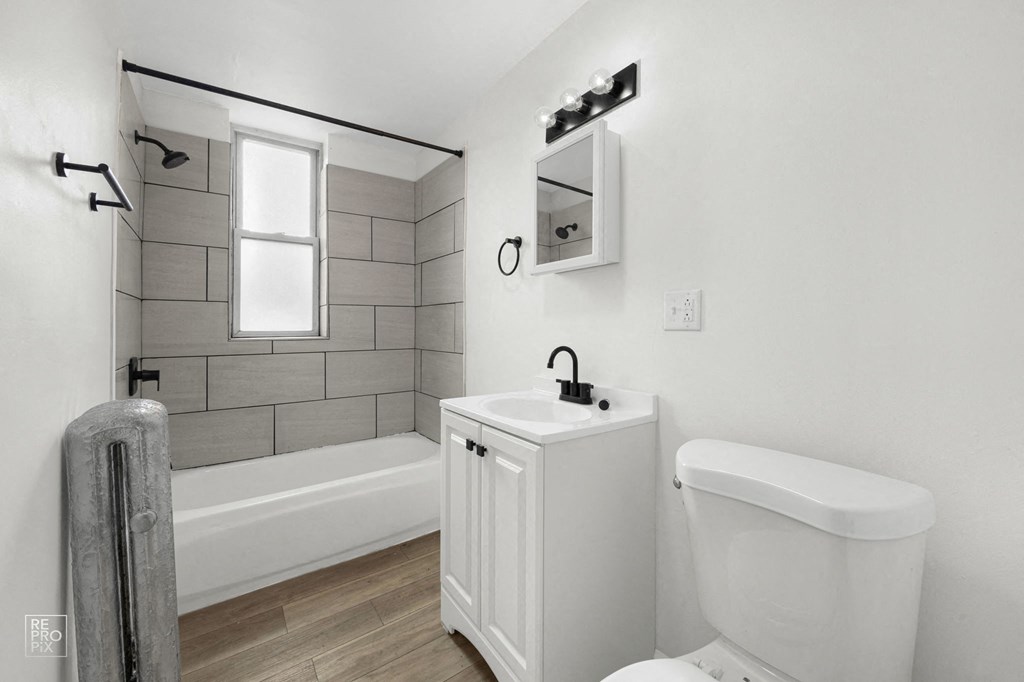 a bathroom with a sink toilet and a bath tub