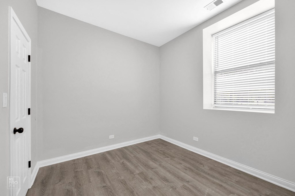 a bedroom with gray walls and a white door