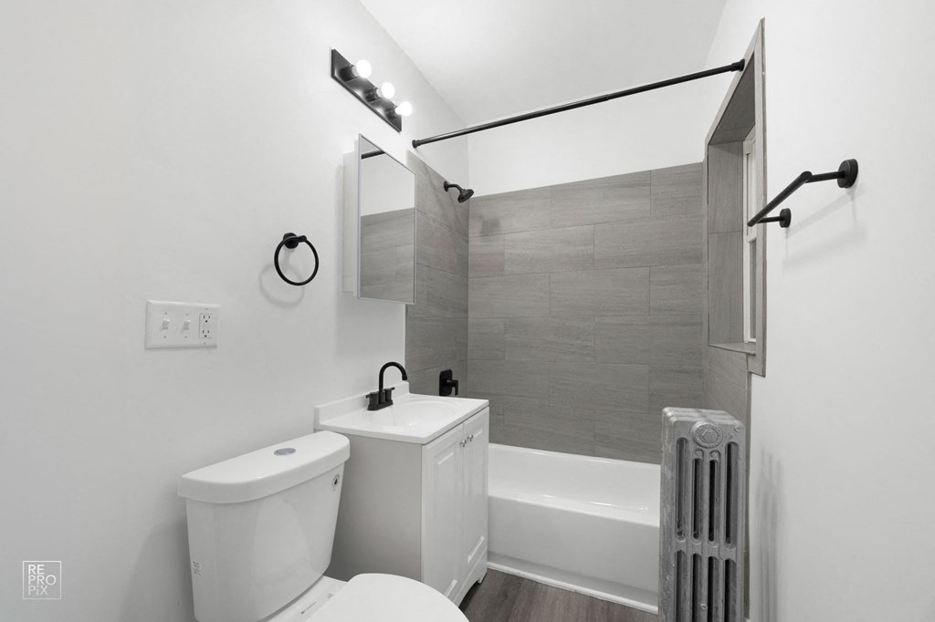 a bathroom with a sink toilet and a bath tub