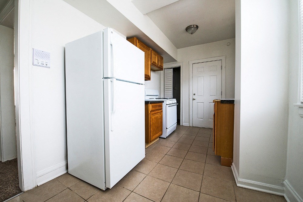 a kitchen with white appliances and wooden cabinets