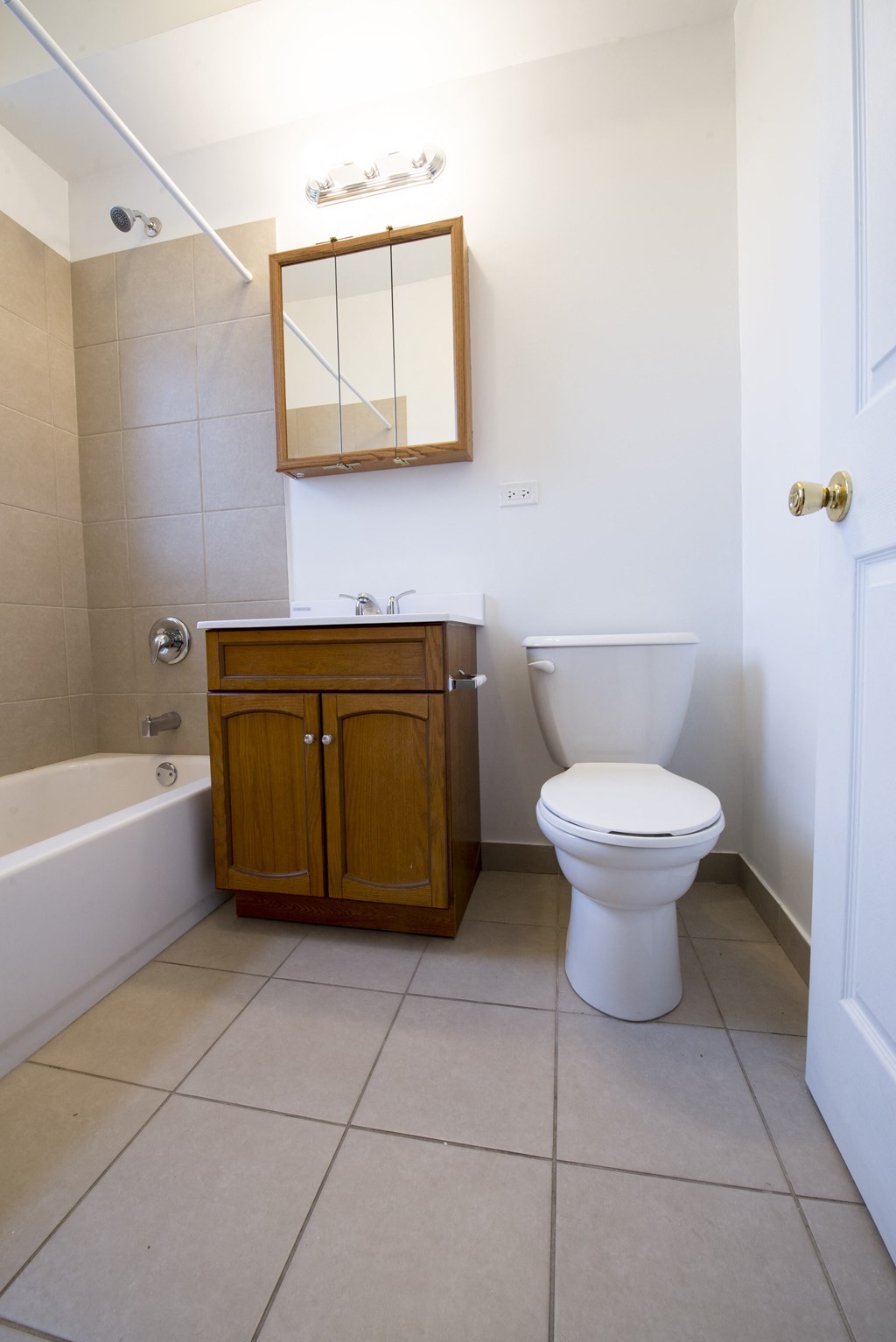 an empty bathroom with a toilet and a cabinet