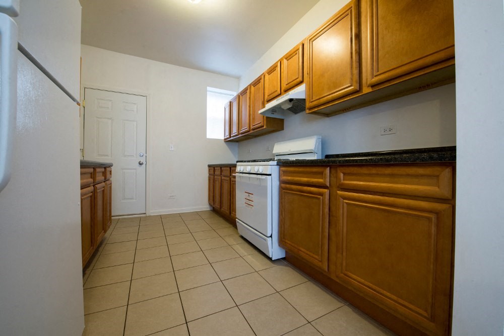 a kitchen with white appliances and wooden cabinets