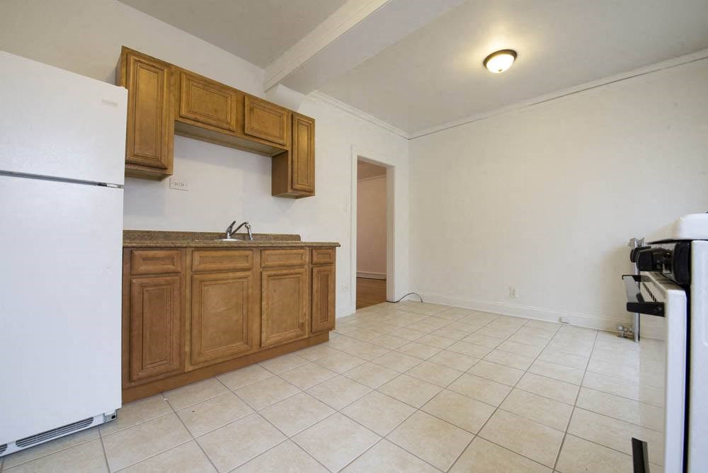 a kitchen with a sink and a refrigerator