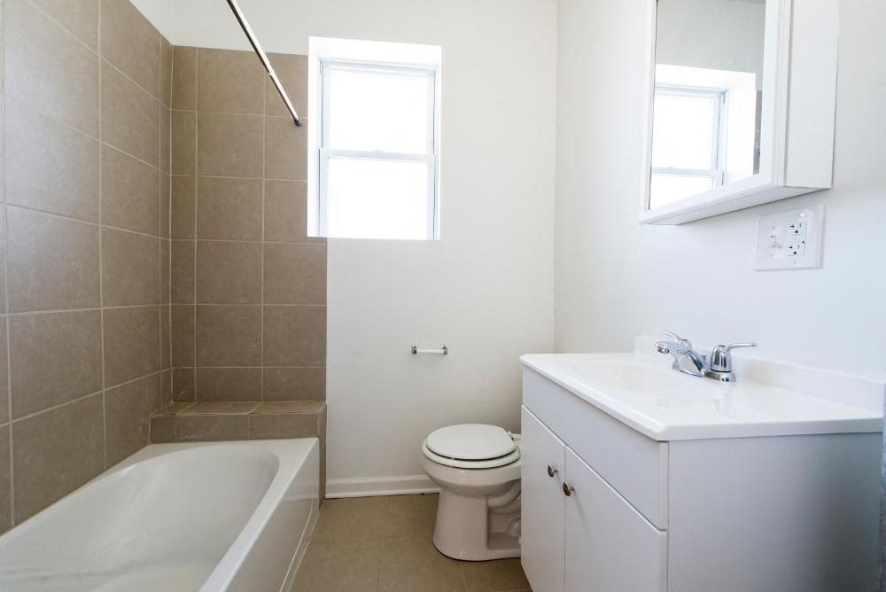 a bathroom with a sink toilet and a bath tub