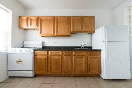 a kitchen with white appliances and wooden cabinets
