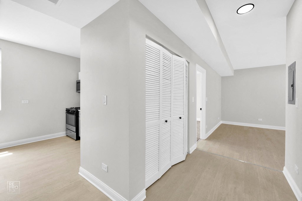 a bedroom with a medium sized bed and a closet with two doors