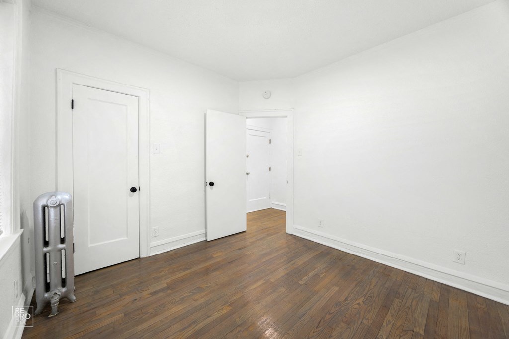 a room with white walls and wooden floors