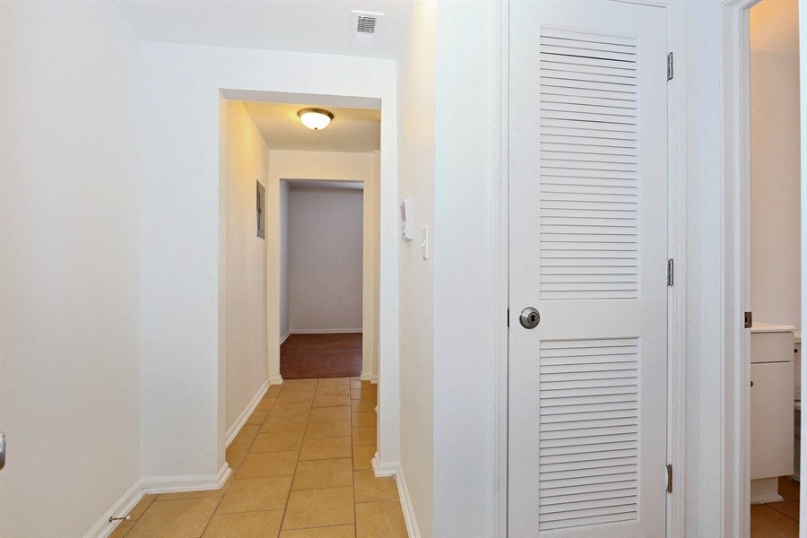 a hallway with a white door and a hallway to a room with a hallway door