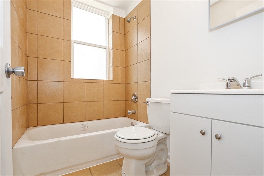 a bathroom with a toilet and a tub and a sink
