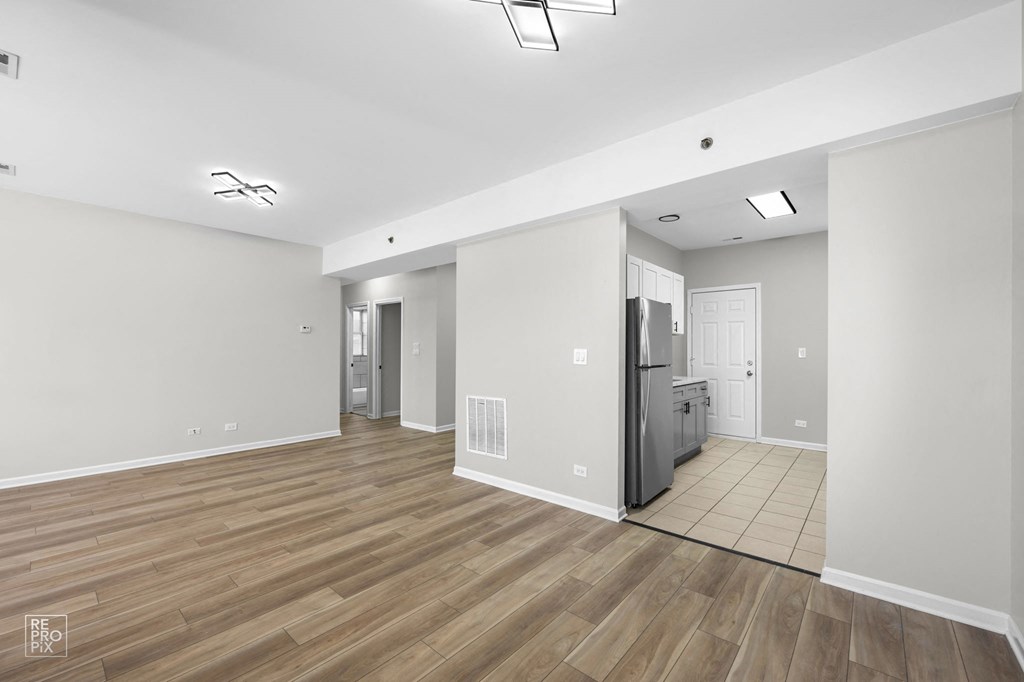 a living room with hardwood floors and grey walls