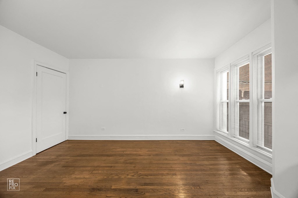 a living room with wood floors and white walls