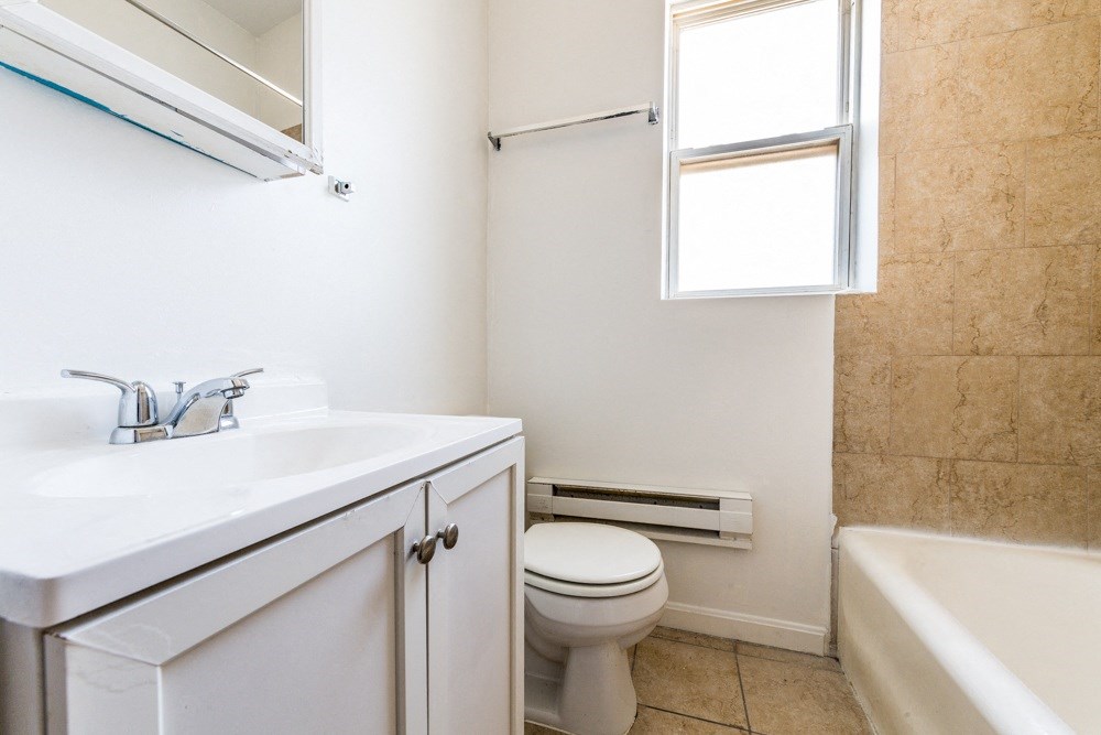 a bathroom with a sink toilet and a bath tub