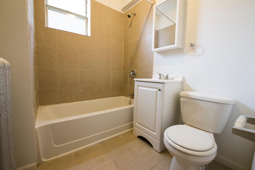 a bathroom with a toilet and a bath tub