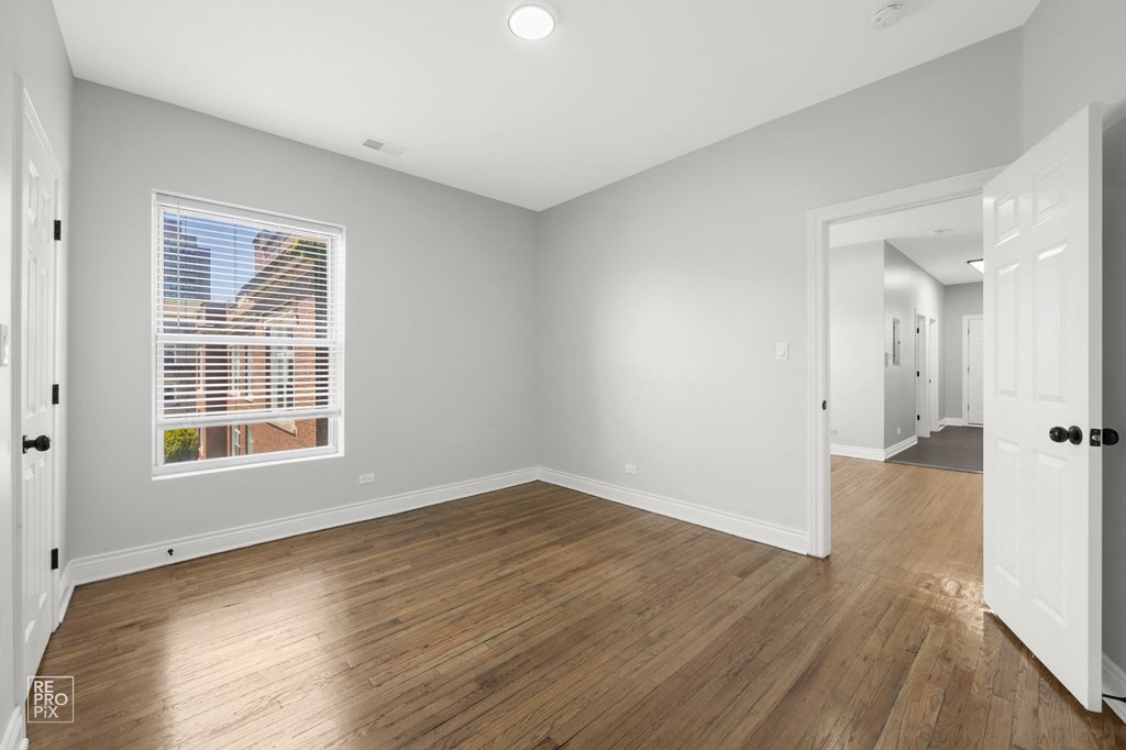 a living room with wood floors and a window