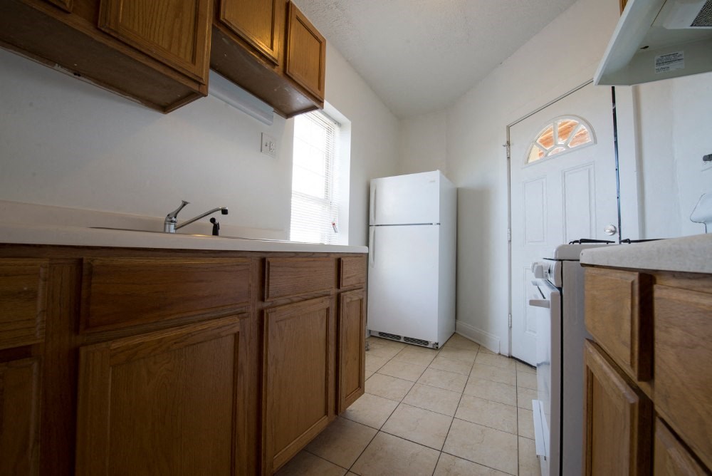 a kitchen with a sink and a refrigerator