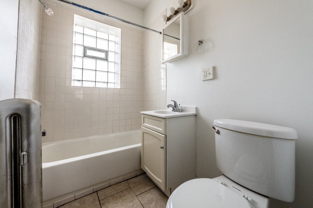 a bathroom with a toilet and a sink and a bath tub