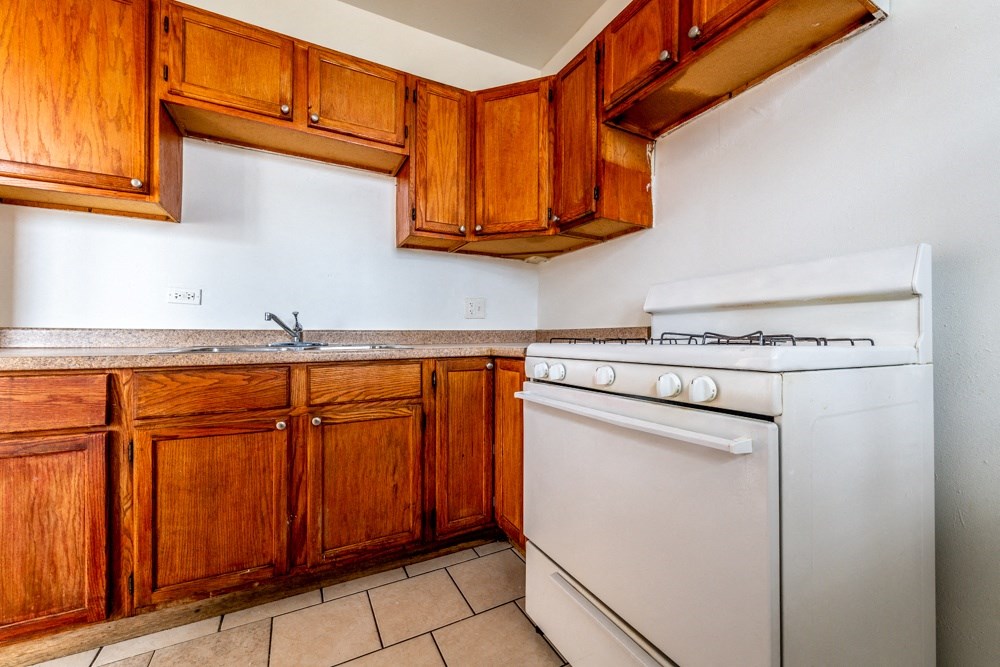 a kitchen with white appliances and wooden cabinets