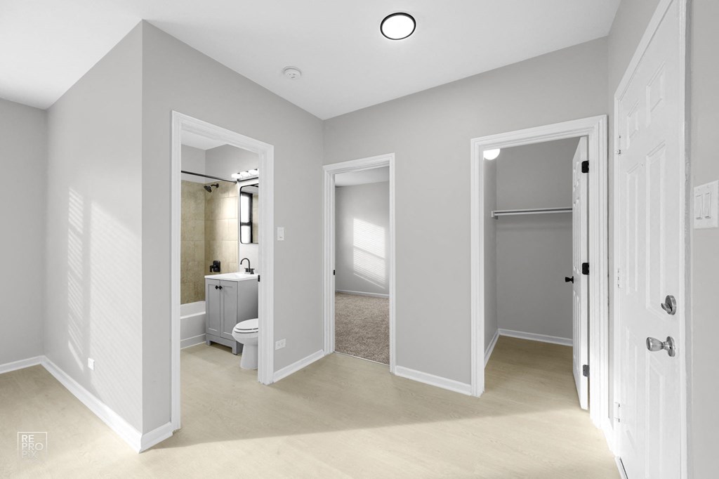 a bedroom and bathroom in a 555 waverly unit