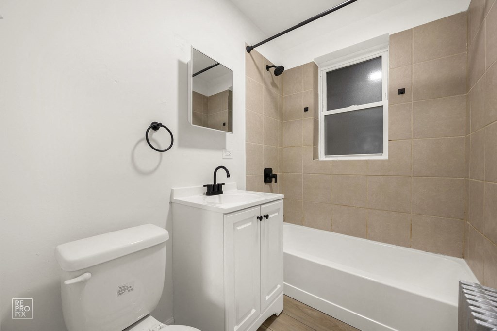 a bathroom with a toilet sink and bath tub
