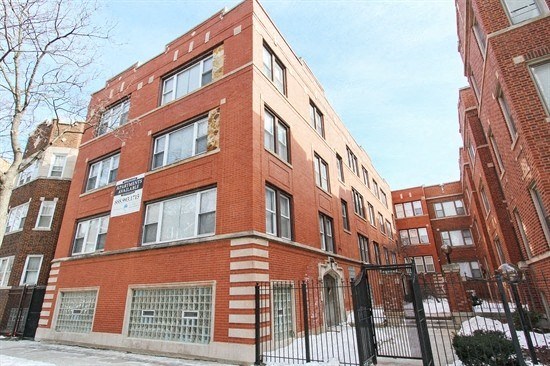 a building with a sign on it in front of a gate